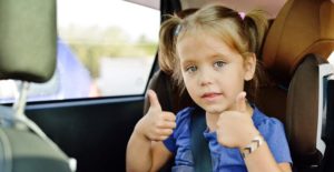 Little girl sitting in a car seat